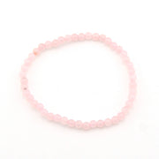 Pink beaded bracelet on a white background