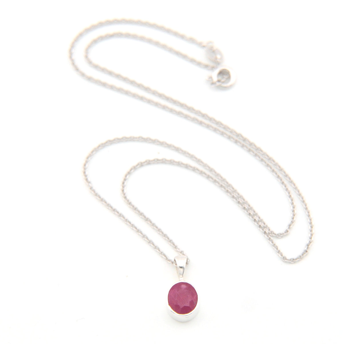 Silver necklace with a pink gemstone pendant on a white background