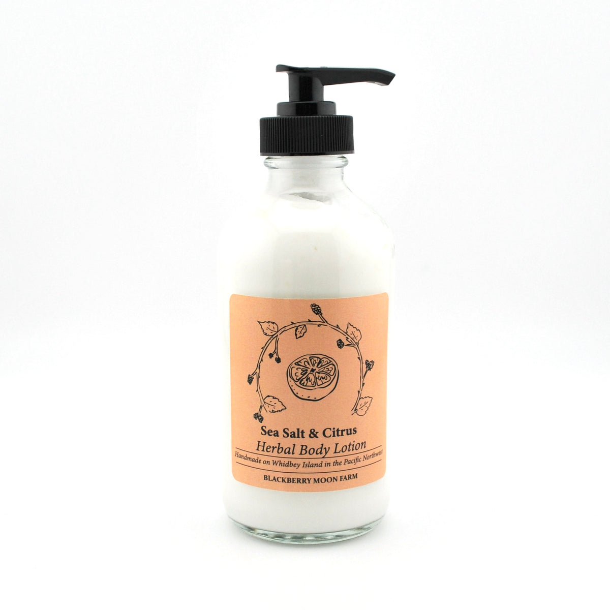 Glass lotion bottle with pump and peach-colored label on a white background