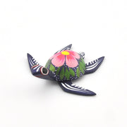 Decorative sea turtle with floral design on a white background