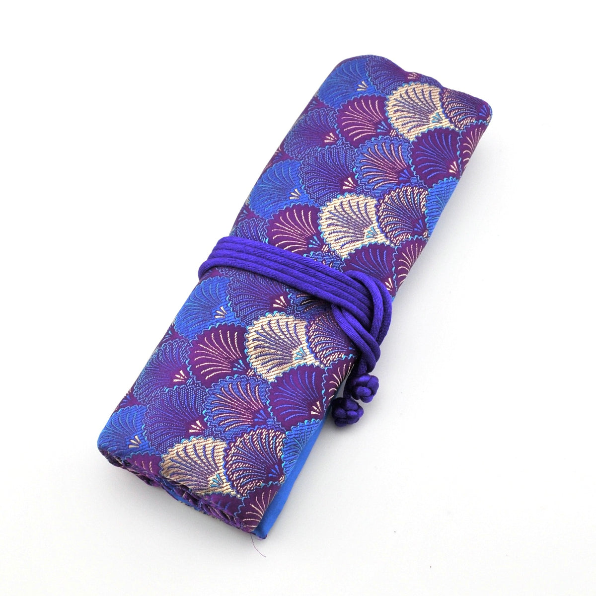 Purple fabric with shell pattern rolled up and tied on a white background