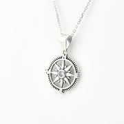 A silver compass pendant necklace on a delicate silver chain, shown against a plain white background.
