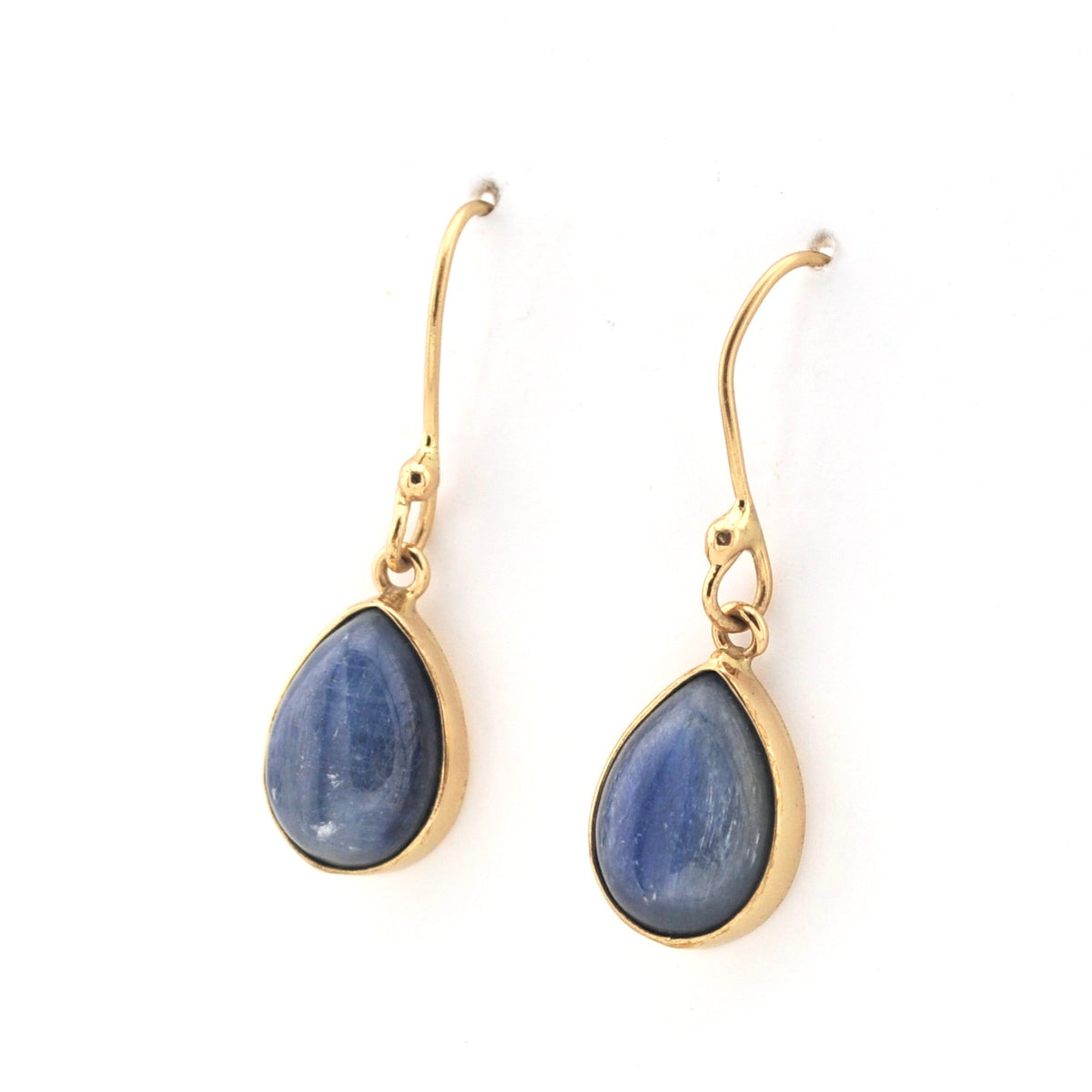 Gold earrings with blue teardrop stones on a white background