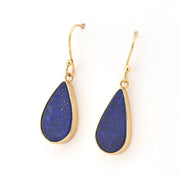 Teardrop-shaped blue earrings with gold hooks on a white background
