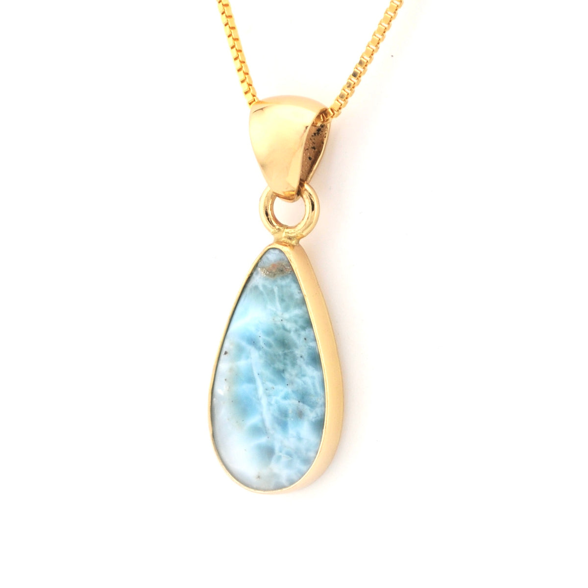 Gold necklace with a teardrop-shaped larimar pendant on a white background