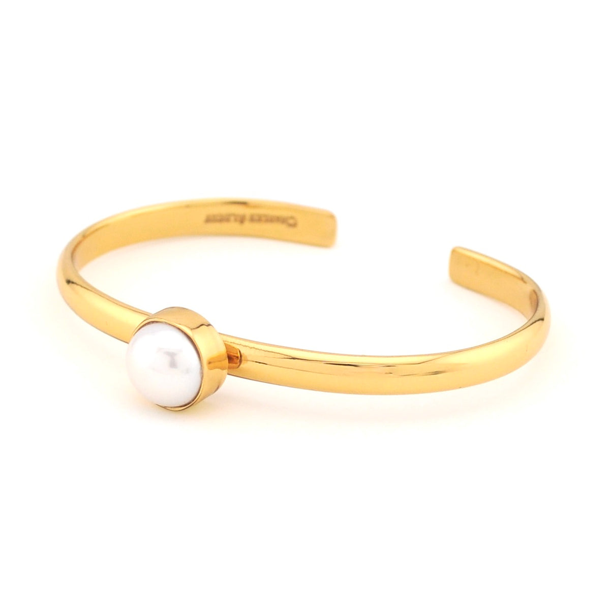 Gold bracelet with a pearl on a white background