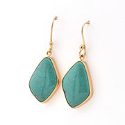 Turquoise earrings with gold hooks on a white background