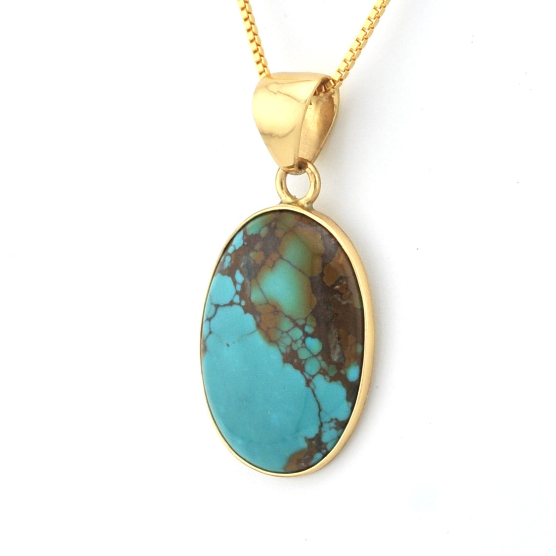 Gold necklace with a turquoise pendant on a white background