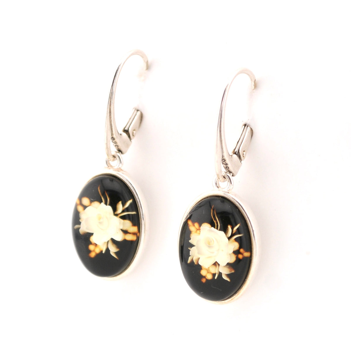 Pair of earrings with floral design on a black background