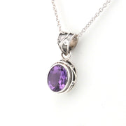 Silver necklace with a purple gemstone pendant on a white background