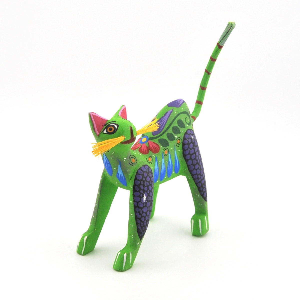 Colorful cat figurine with artistic design on a white background