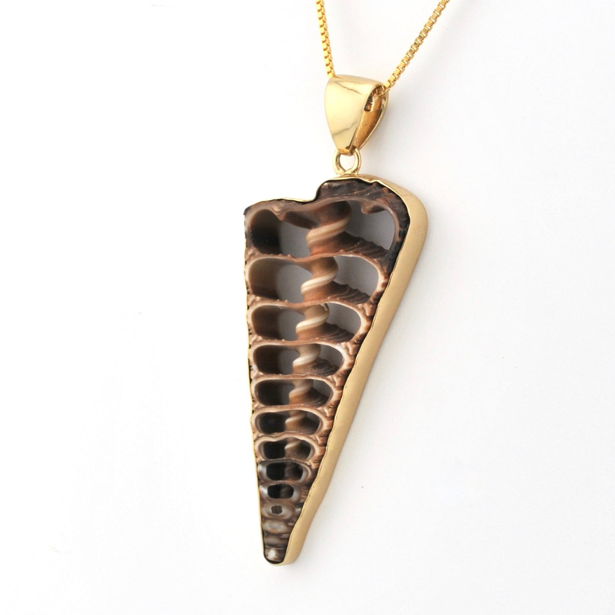 Gold and bronze pendant on a white background