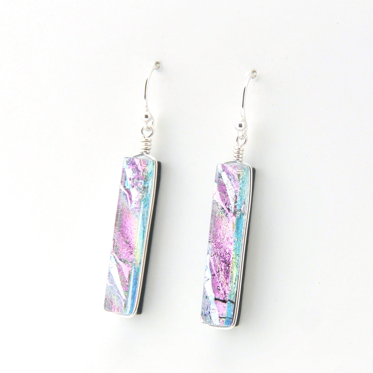 Pair of earrings with pink and blue marbled design on a white background
