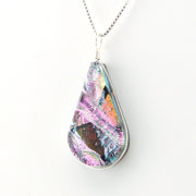Teardrop-shaped pendant with multicolored design on a white background