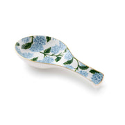 Decorative ceramic spoon rest with floral pattern on a white background