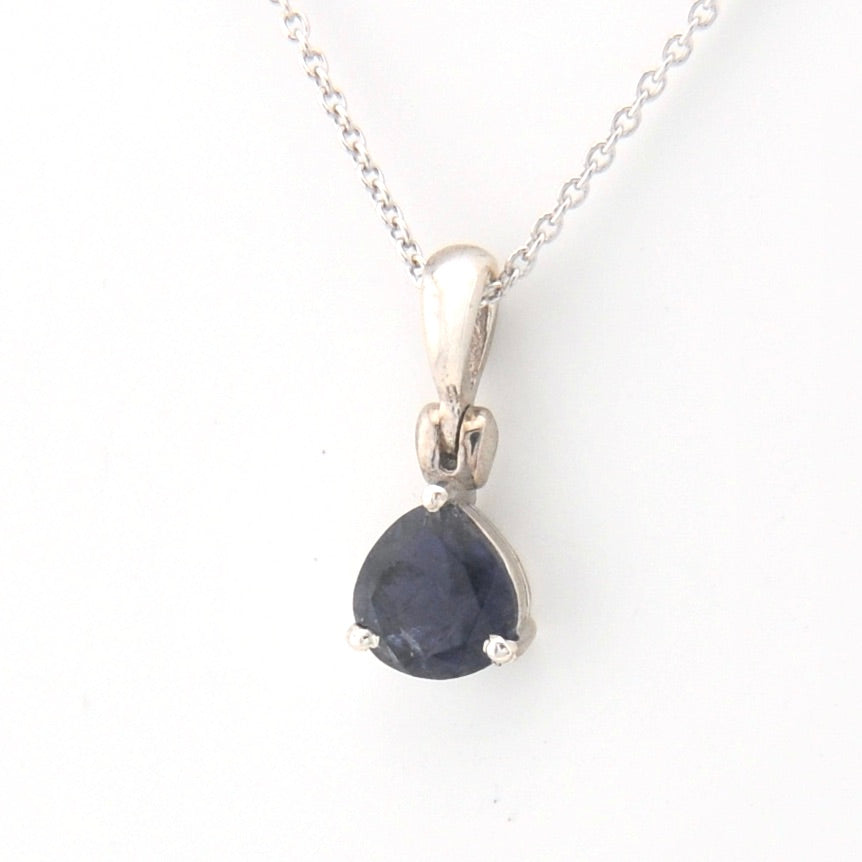 Silver pendant with a blue gemstone on a white background