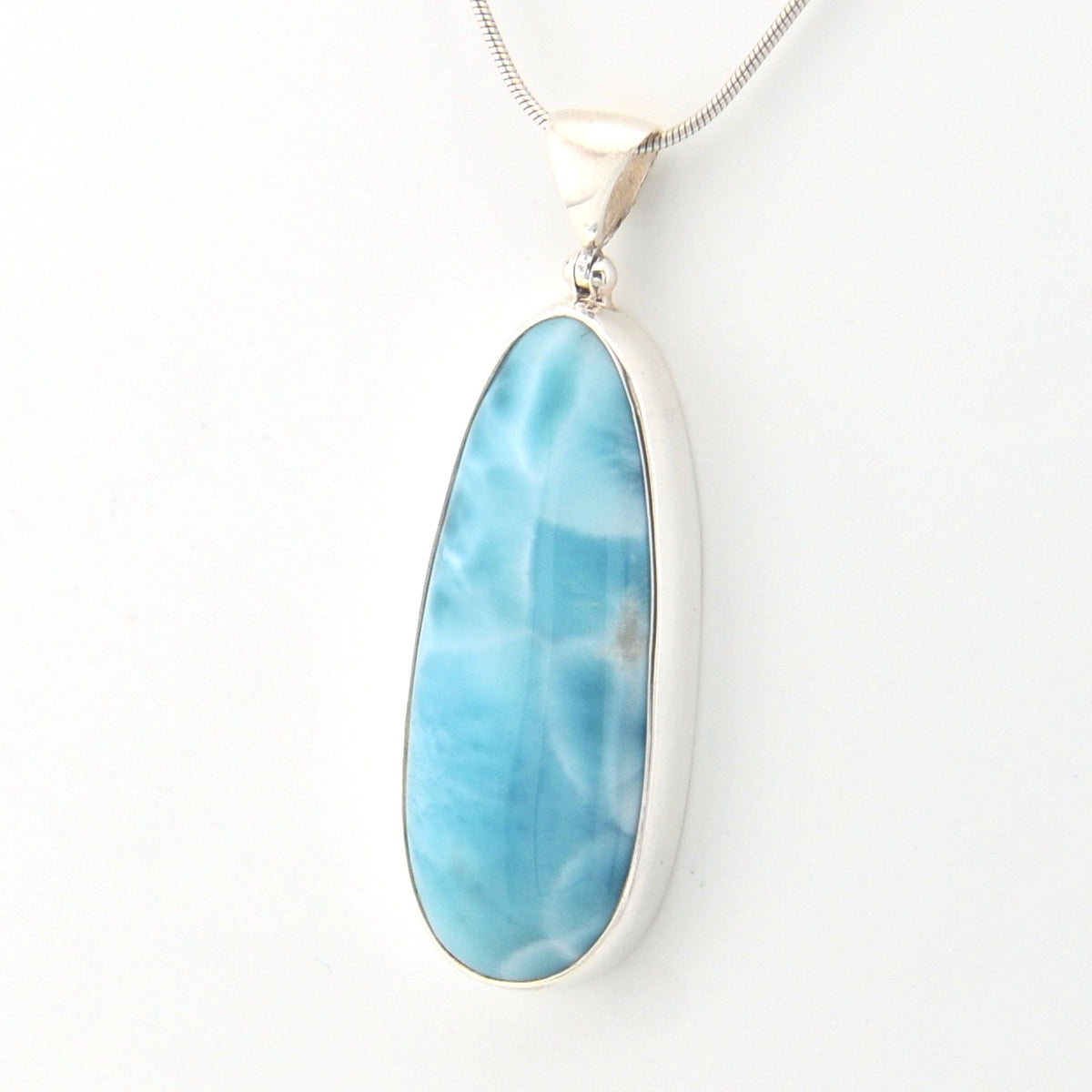 Blue larimar pendant on a white background