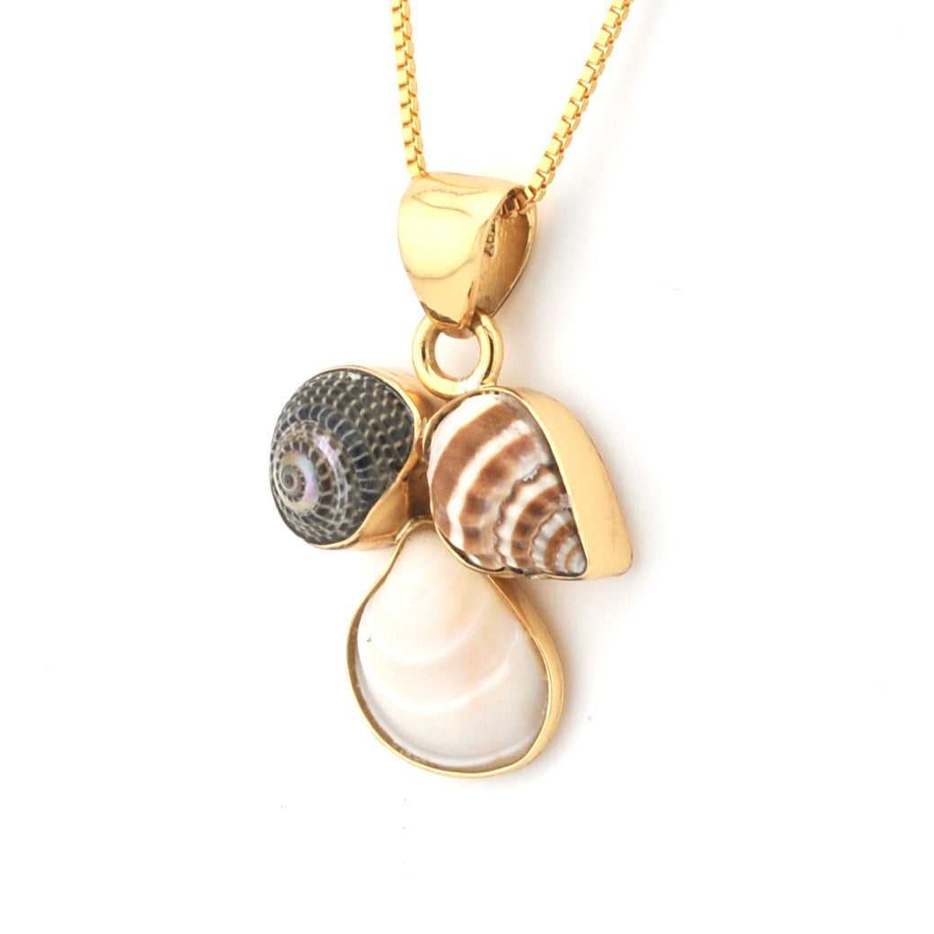 Gold necklace with shell and pearl pendant on a white background