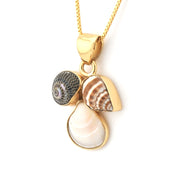 Gold necklace with shell and pearl pendant on a white background