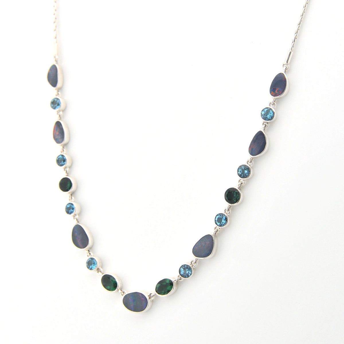Necklace with blue and green gemstones on a white background