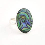 Ring with an abalone shell design on a white background