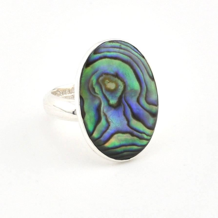 Ring with an abalone shell design on a white background