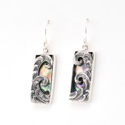 Pair of earrings with wave design on a white background