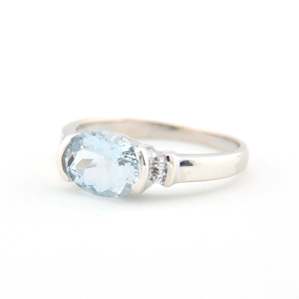 Silver ring with a blue gemstone on a white background