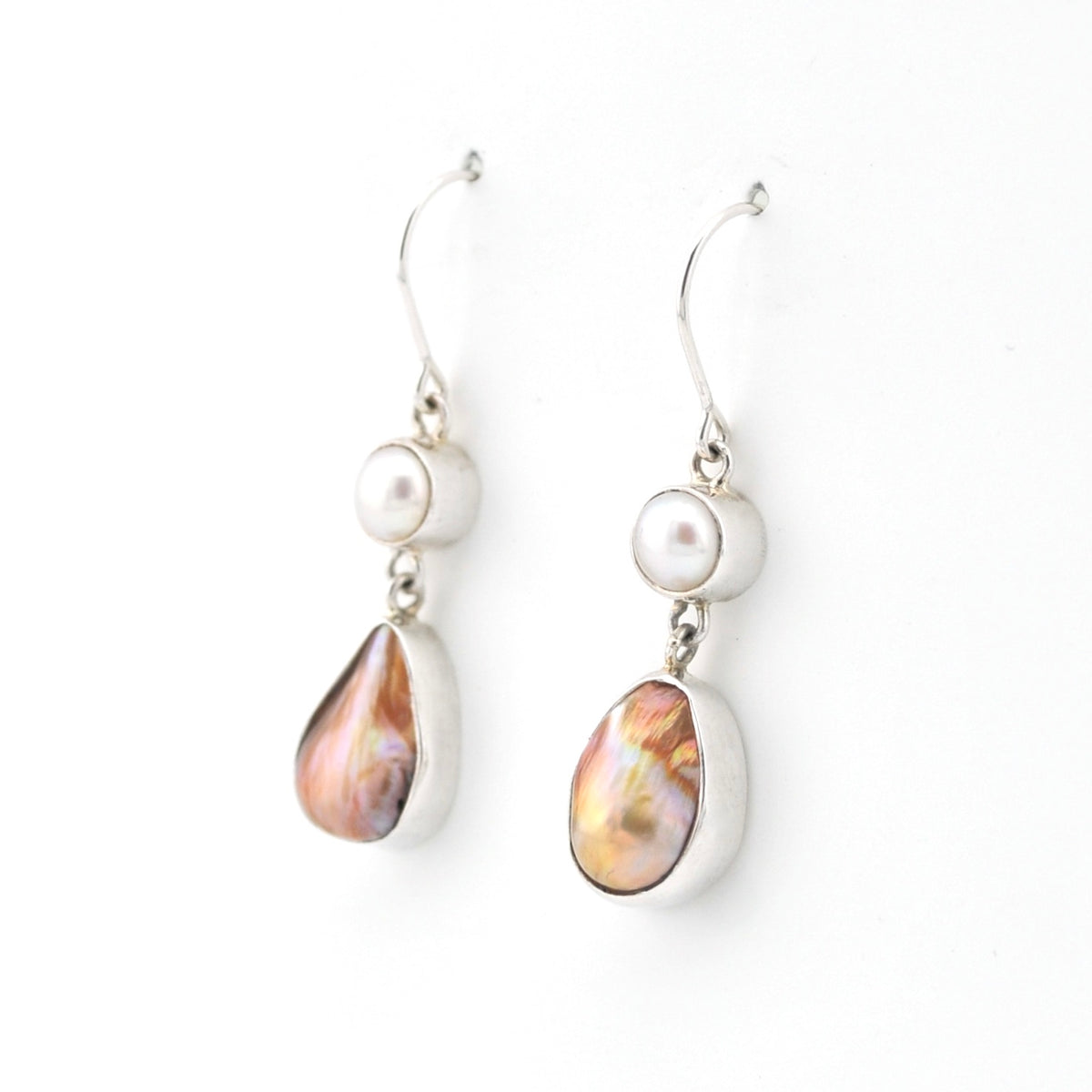 Pair of earrings with pearl and teardrop-shaped gemstone on a white background