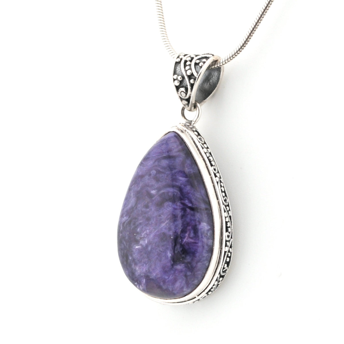 Purple teardrop pendant with silver frame on a white background