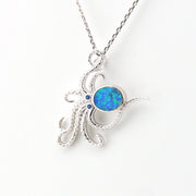 Silver pendant with a blue opal stone on a white background