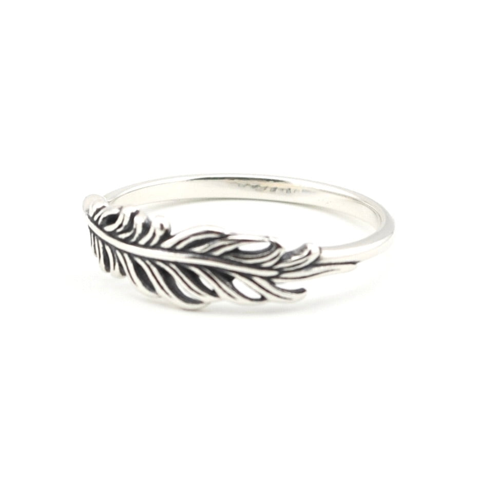 A sterling silver feather ring with an oxidized dark finish in the recessed details, shown on a plain white background.