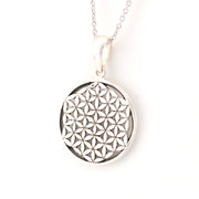 Silver necklace with a round pendant featuring a geometric pattern on a white background