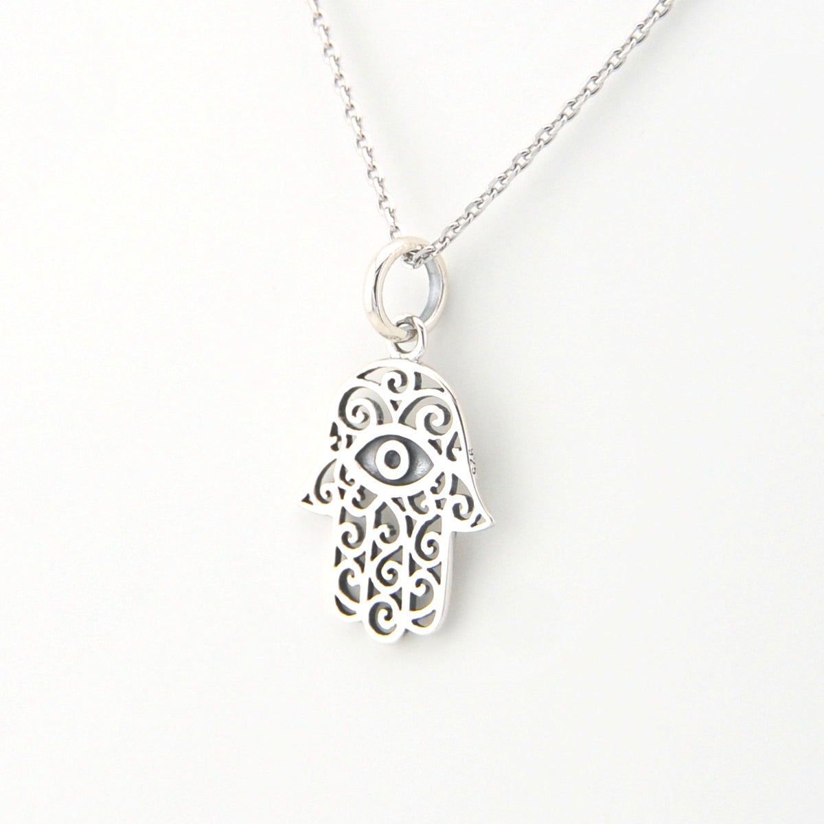 Silver Hamsa hand necklace on a white background
