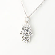 Silver Hamsa hand necklace on a white background