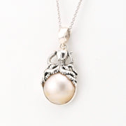 Pearl pendant with octopus necklace on a white background