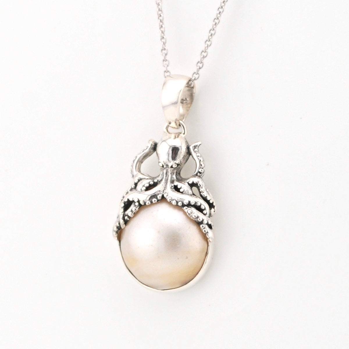 Pearl pendant with octopus necklace on a white background