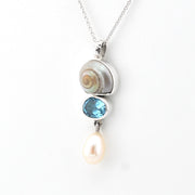 Silver pendant with a pearl and blue gemstone on a white background