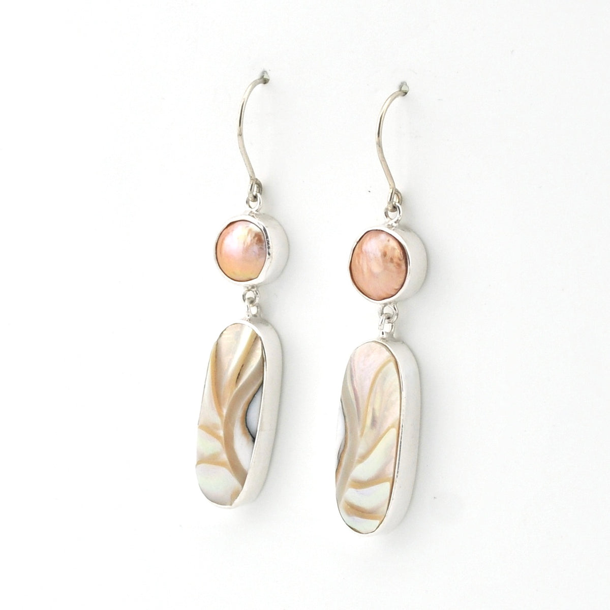 Pair of earrings with shell-like design on a white background