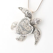 Silver turtle pendant necklace on a white background