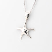 Silver starfish pendant on a chain against a white background