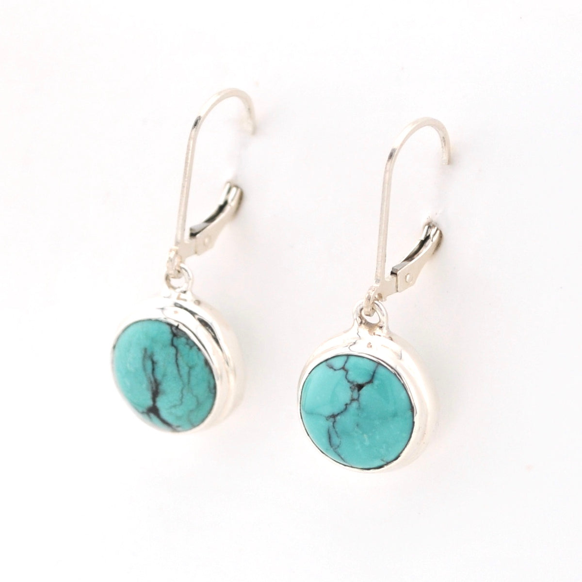 Turquoise stone earrings with silver hooks on a white background