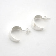 Silver hoop earrings on a white background