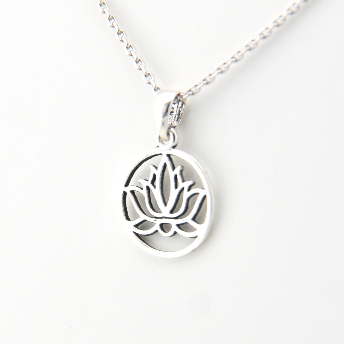 Silver necklace with a lotus flower pendant on a white background