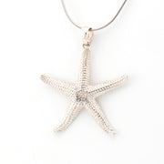 Silver starfish pendant on a white background