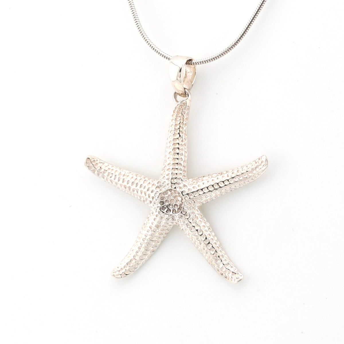 Silver starfish pendant on a white background
