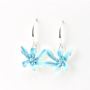 Light blue flower-shaped earrings on a white background