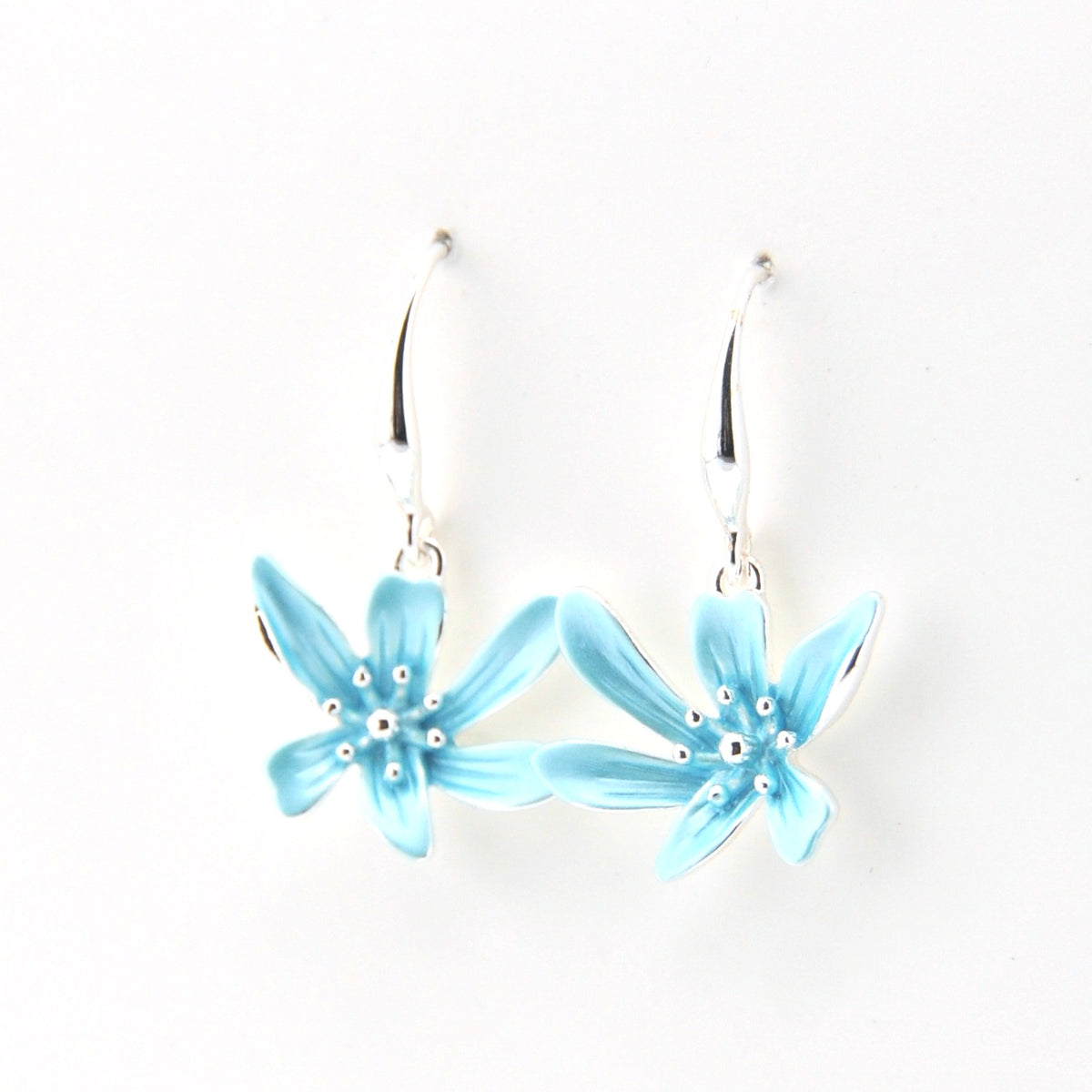 Light blue flower-shaped earrings on a white background
