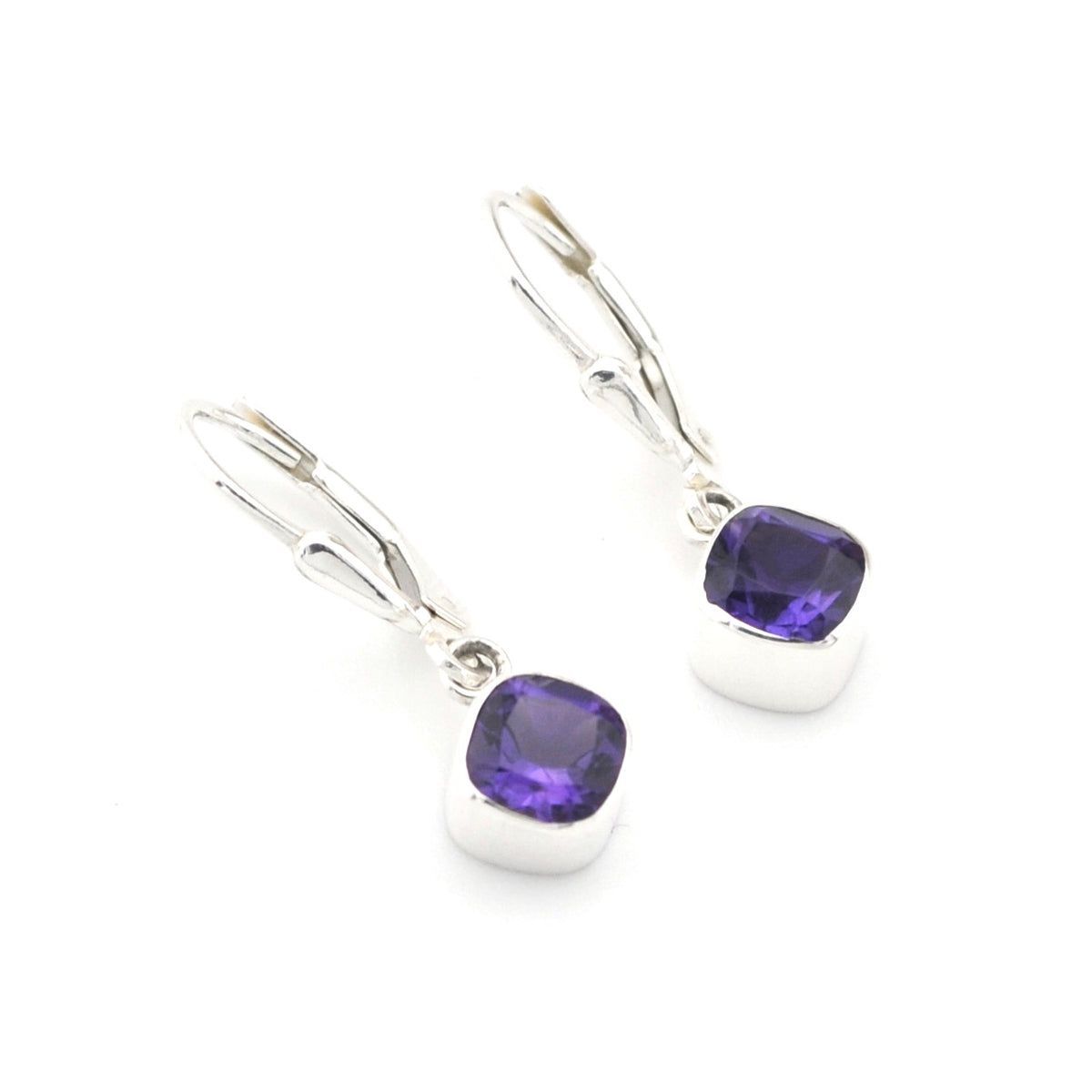 Silver earrings with purple gemstones on a white background