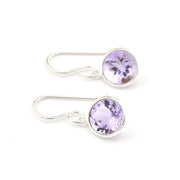 Silver earrings with purple gemstones on a white background